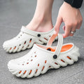 Beige men's EVA slipper sandals with hollow out pattern and non-slip sole.