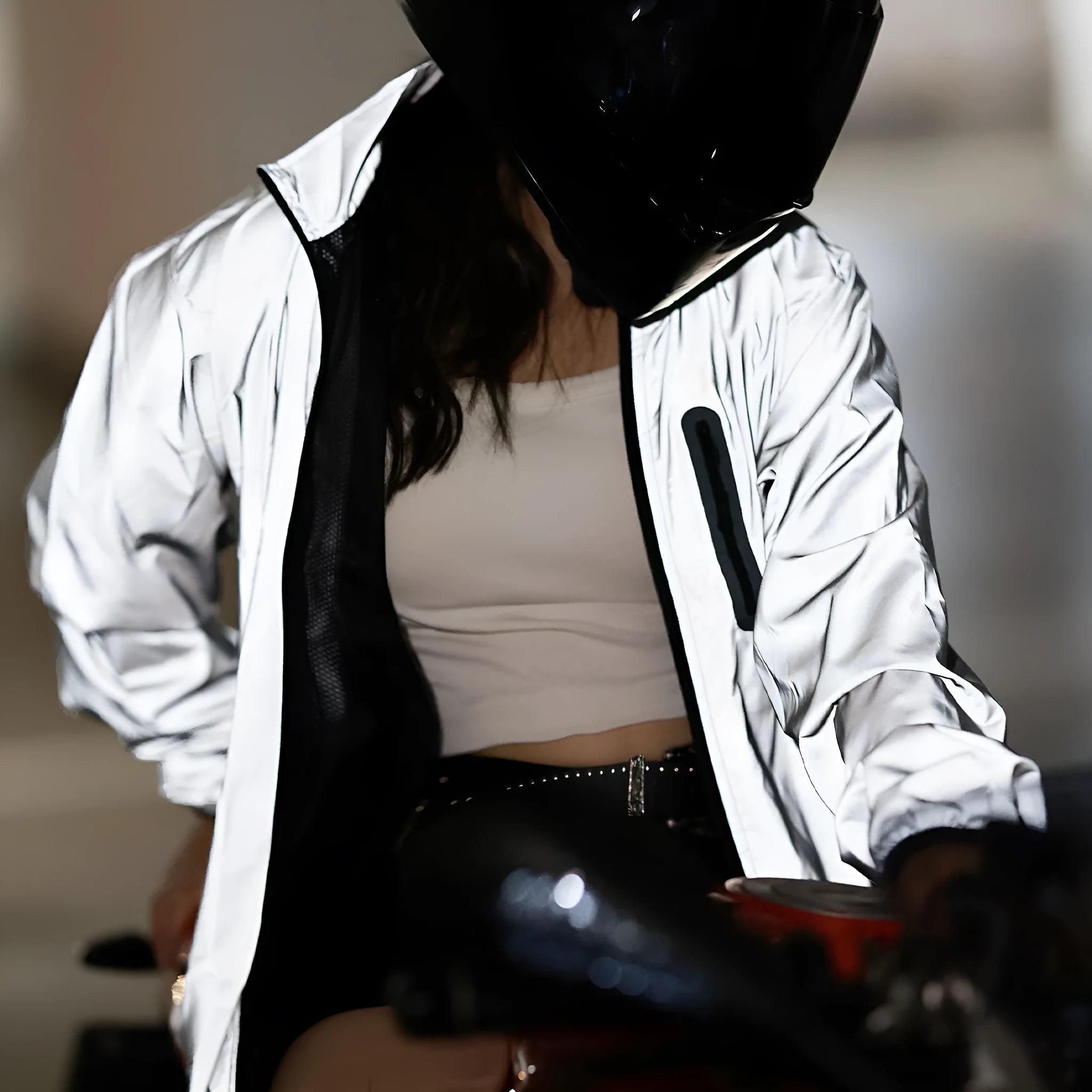 Silver waterproof polyester windbreaker jacket with long sleeves shown on a hanger.