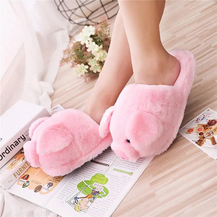 Pink pig character plush floor slippers on a white background