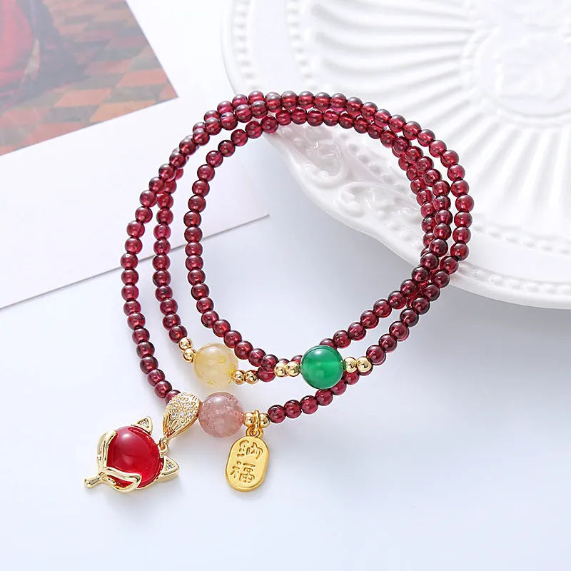 Purplish red garnet crystal fox bracelet with adjustable rope fastening for women