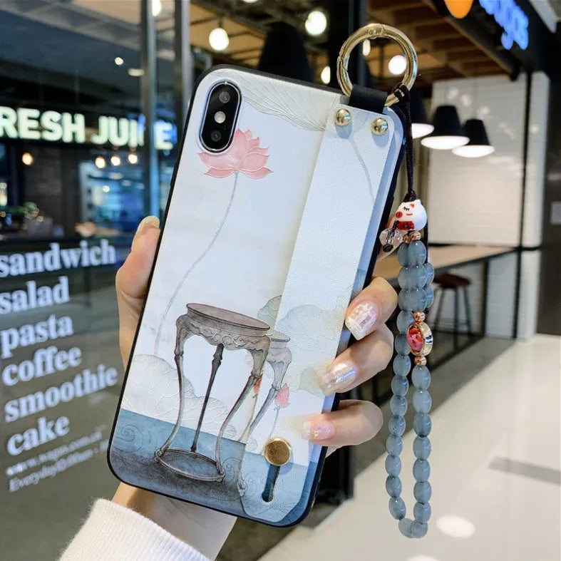 Rose flower design wrist strap case for iPhone on a table