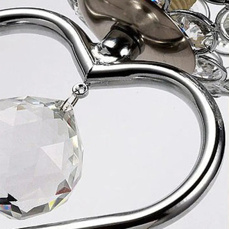 Modern minimalist crystal USB table lamp with heart-shaped design on a bedside table