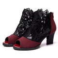 Women's black lace gladiator sandals with square heels and floral patterns, showing zip closure and peep toe design