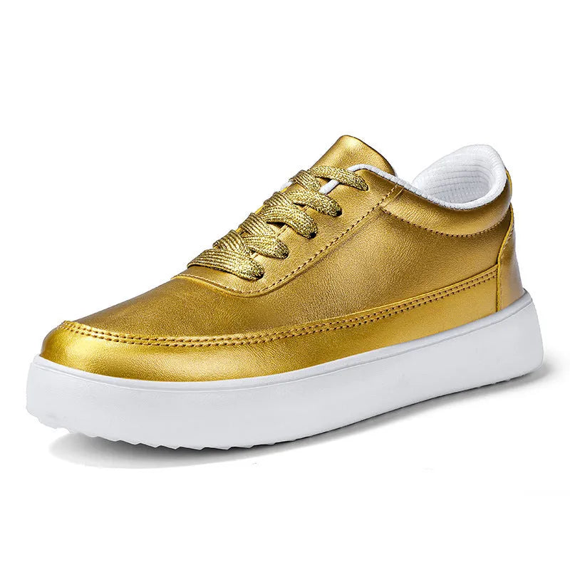 Women's leather flat casual shoes in gold colour with front lace-up closure on a white background.