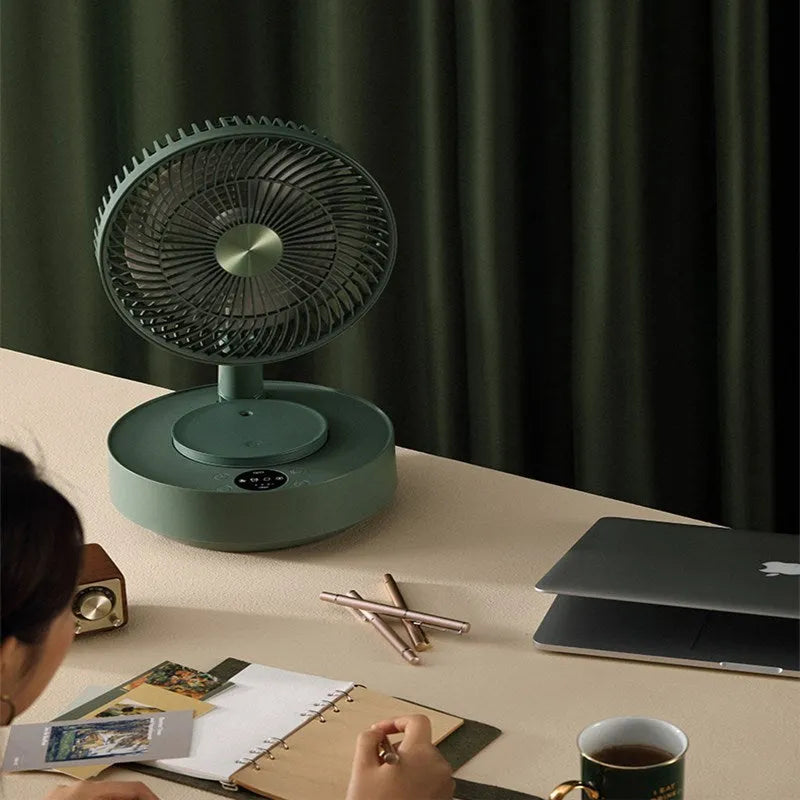 Green telescopic floor fan extended to full height with magnetic remote control attached