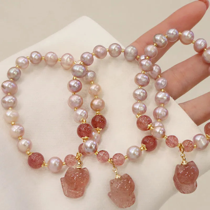 Women's light pink freshwater pearl bracelet with strawberry quartz beads and fox charm