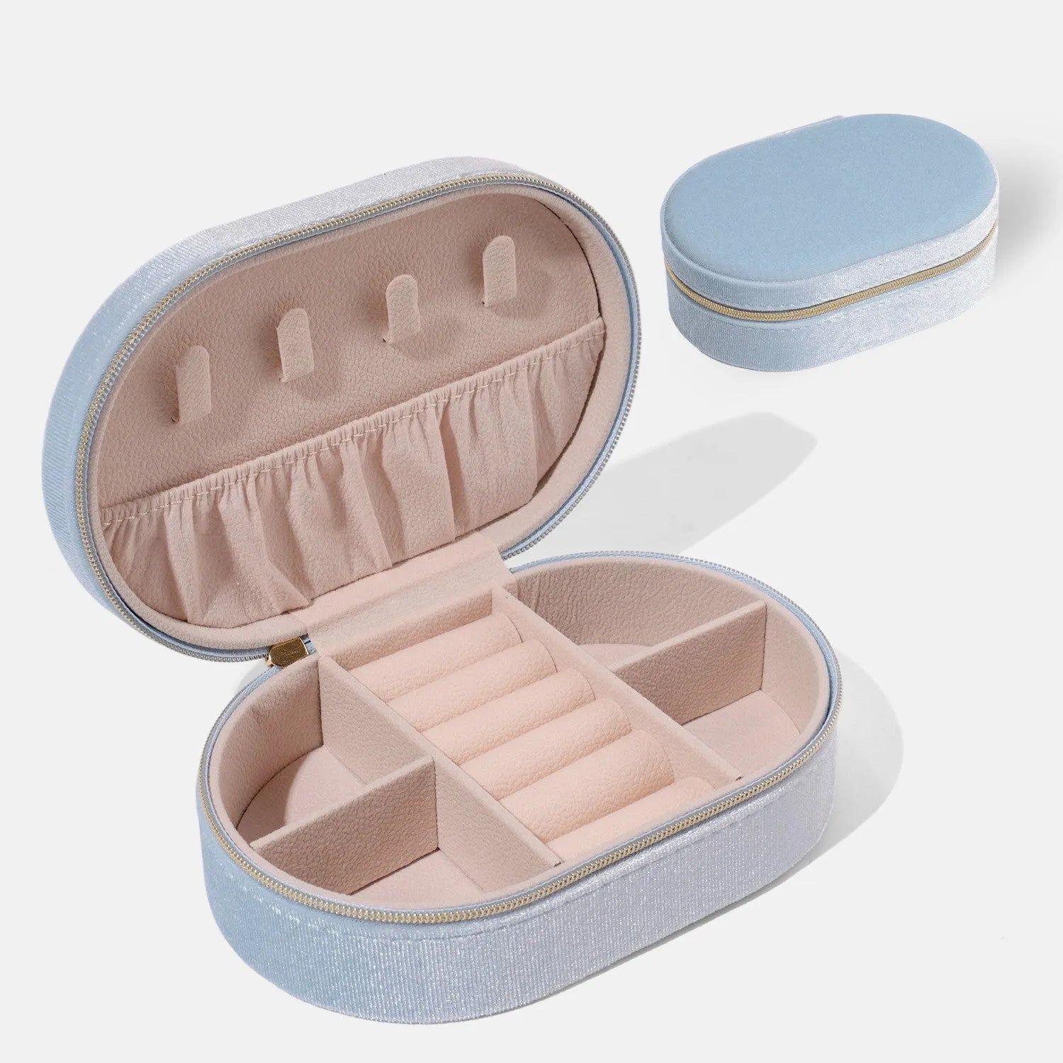 Oval velvet jewellery storage box in lake blue with flannel interior, measuring 15 by 10 cm.