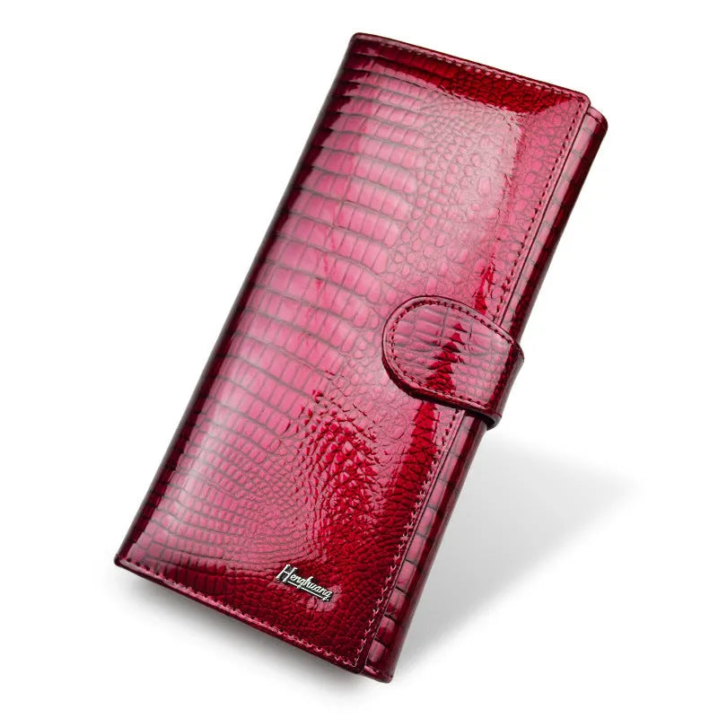 Women's red crocodile pattern patent leather coin purse with pigskin lining.