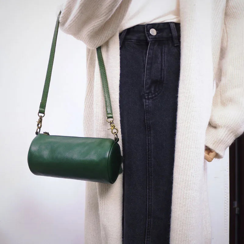 Top layer cowhide leather round single-shoulder bag in caramel brown with wide strap and sewing thread details