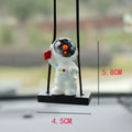 Resin cartoon astronaut car pendant in five designs: telescope, red flag, radish, headrest, and resting astronaut