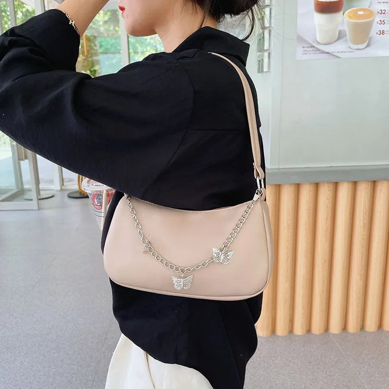 Butterfly chain shoulder crossbody bag in horizontal square shape with separate internal compartments