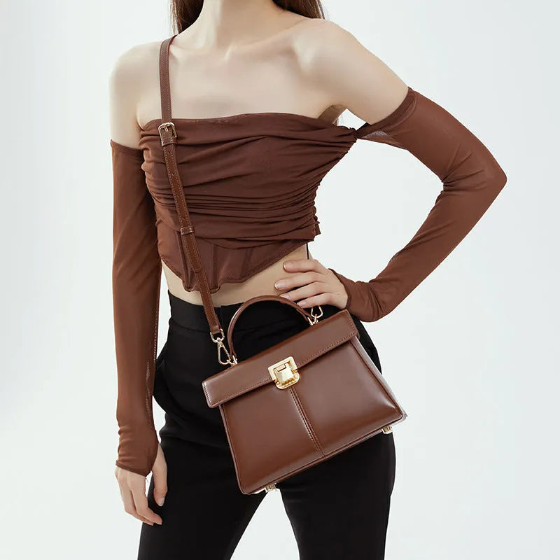 Dark brown women's genuine leather shoulder bag with a metal Vachette clasp, shown open to reveal an interior zippered pocket.