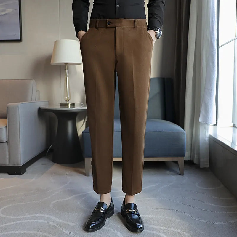 Straight-leg brown corduroy trousers with an elastic waistband laid flat.