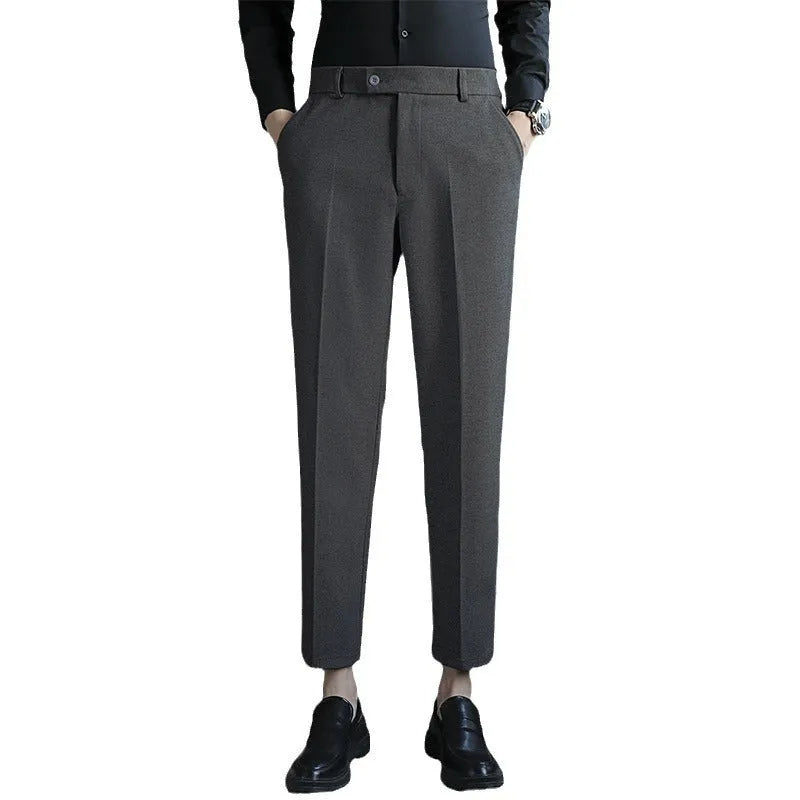 Straight-leg brown corduroy trousers with an elastic waistband laid flat.