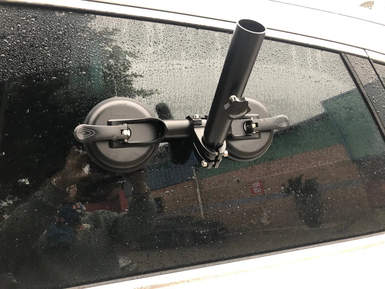 Black off-road car glass sucker base with round rubber disc for windscreen mounting.