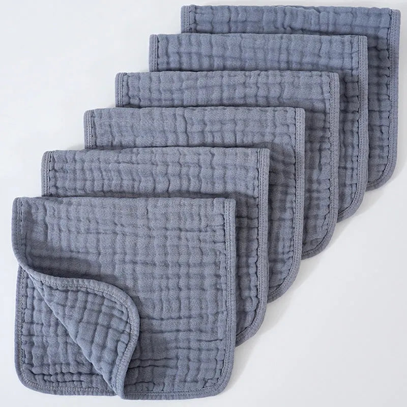 Set of six large muslin burp cloths 25x50cm in assorted colours on white background