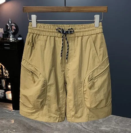 Man wearing olive camouflage cargo shorts with a loose fit and cargo pockets.