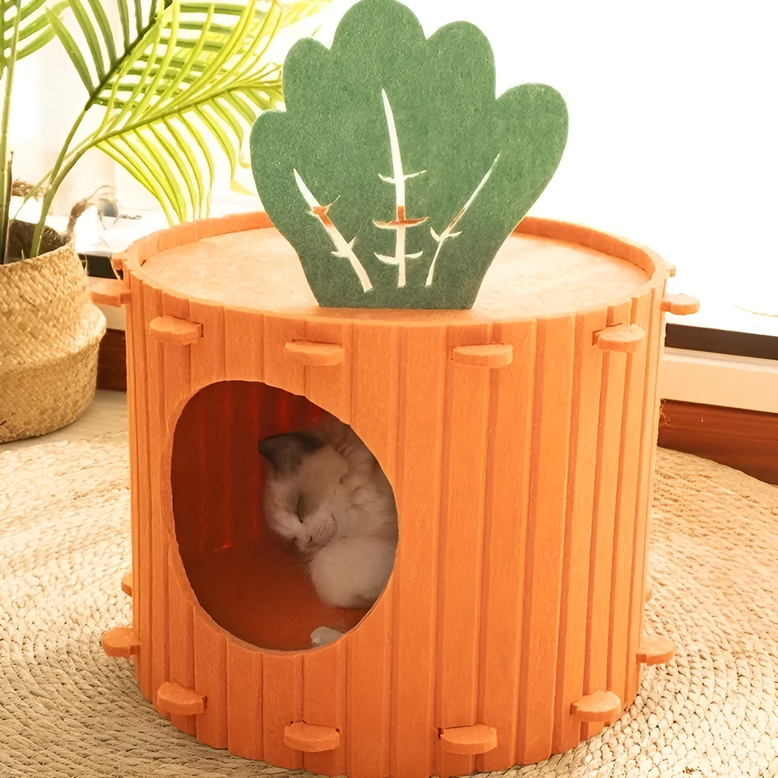 Beige carrot-shaped felt cat nest with multiple holes, shown in a home setting.