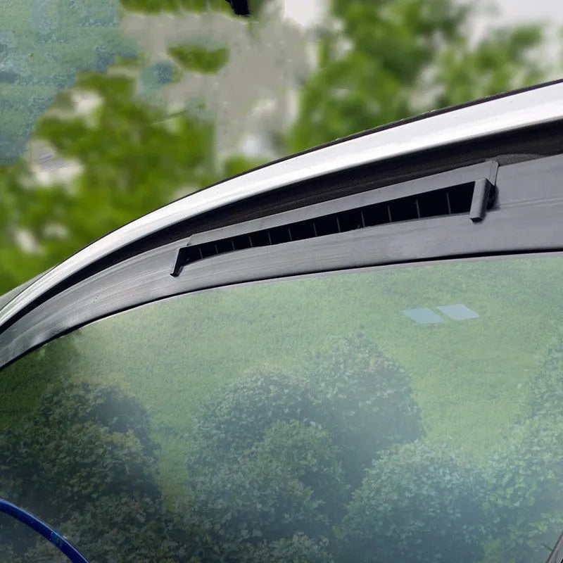Black and white car ventilation fan with USB cable for reducing cabin heat and odours