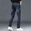 Men's slim straight casual trousers in blue grey, showing loose fit and street style.