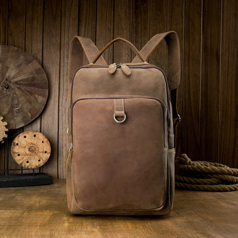 Retro brown leather backpack for men, 20L bucket shape with zipper, laptop pocket and phone pouch.