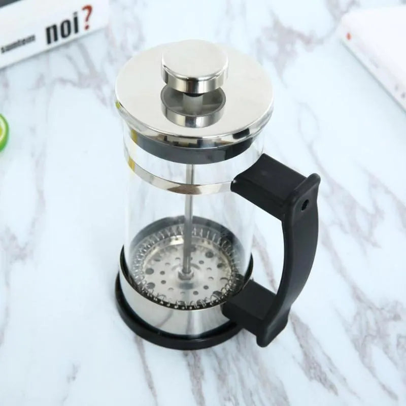 Compact glass French press coffee maker with stainless steel frame, 350ml capacity.