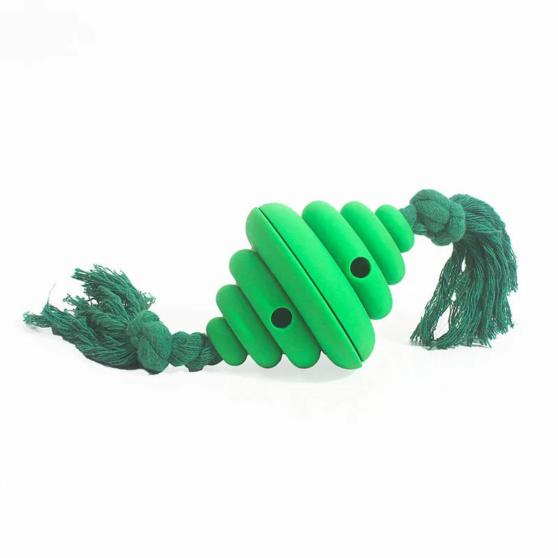 Green and yellow silicone dog ball with attached knot rope toy on grass