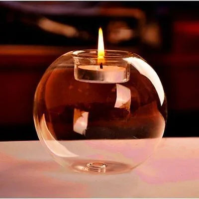 Handmade clear round hollow glass candle holder in European style on a table.