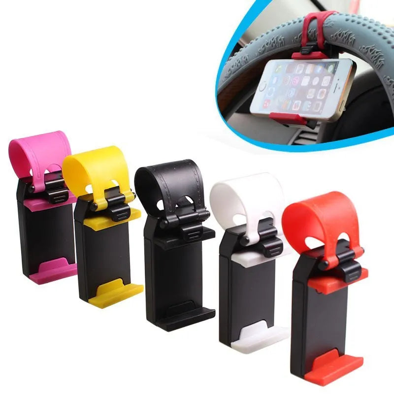 Black universal steering wheel phone holder clip mounted on a car steering wheel, holding a smartphone.