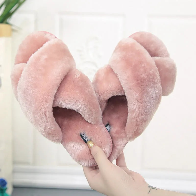 Women's black open-toe fur slippers with a cross-strap design and textured non-slip rubber sole.