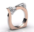 Geometric couple ring with zircon stone in rose gold on a grey background.