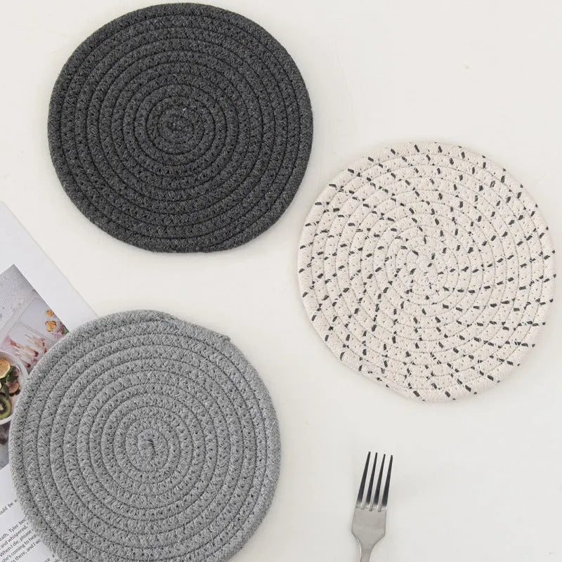 Three round cotton cord coasters in 18cm diameter showing grey, pink, purple and blue colour options