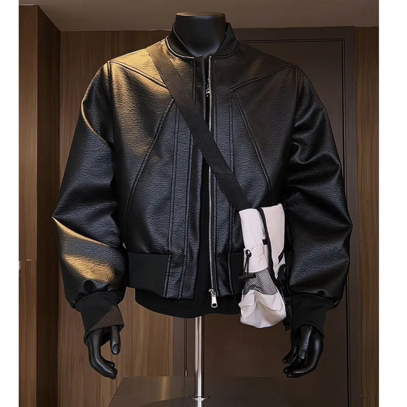 Man wearing a long black PU leather jacket with a tight fit and light business style.