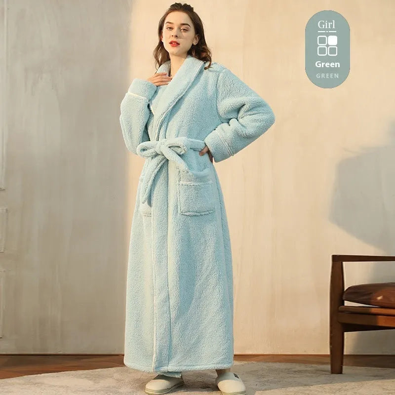 A man and woman wearing matching navy blue thick flannel bathrobes, showcasing the wrap-around design and plush fabric.