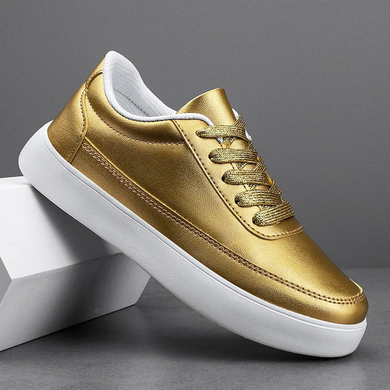 Women's leather flat casual shoes in gold colour with front lace-up closure on a white background.