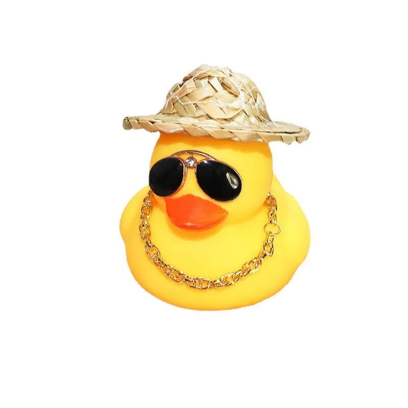Yellow duck car ornament with straw hat and sunglasses on car dashboard