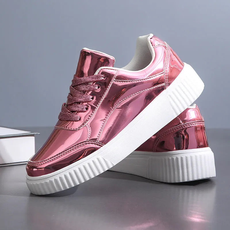 Gold sequinned platform sneakers with thick sole and round toe on a white background.