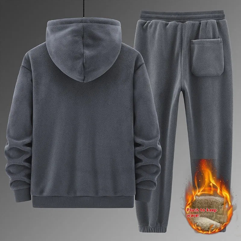 Man wearing a grey hooded sweater and matching casual trousers from a two-piece set.