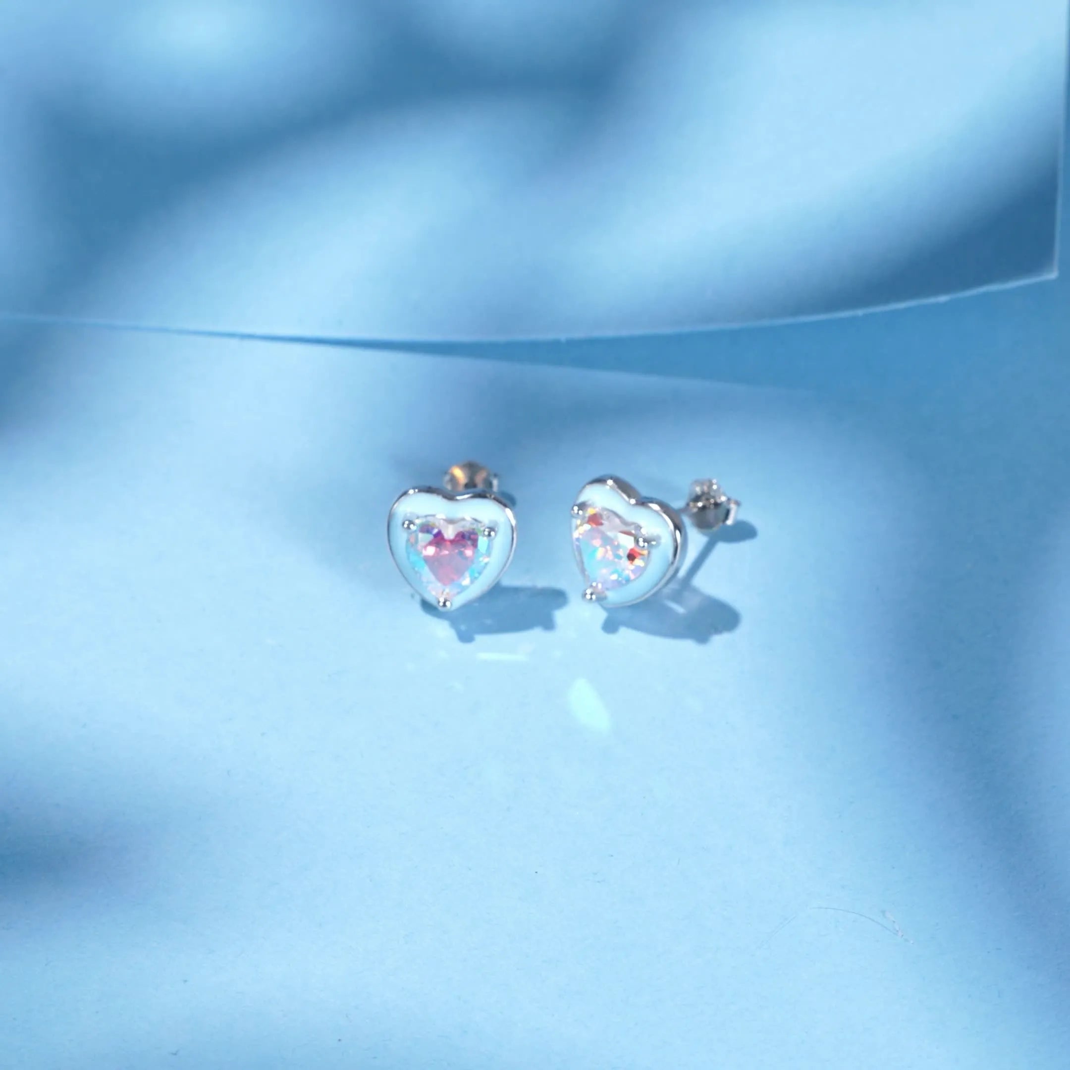 S925 sterling silver heart-shaped stud earrings with colourful zircon mosaic and epoxy accents on silver background