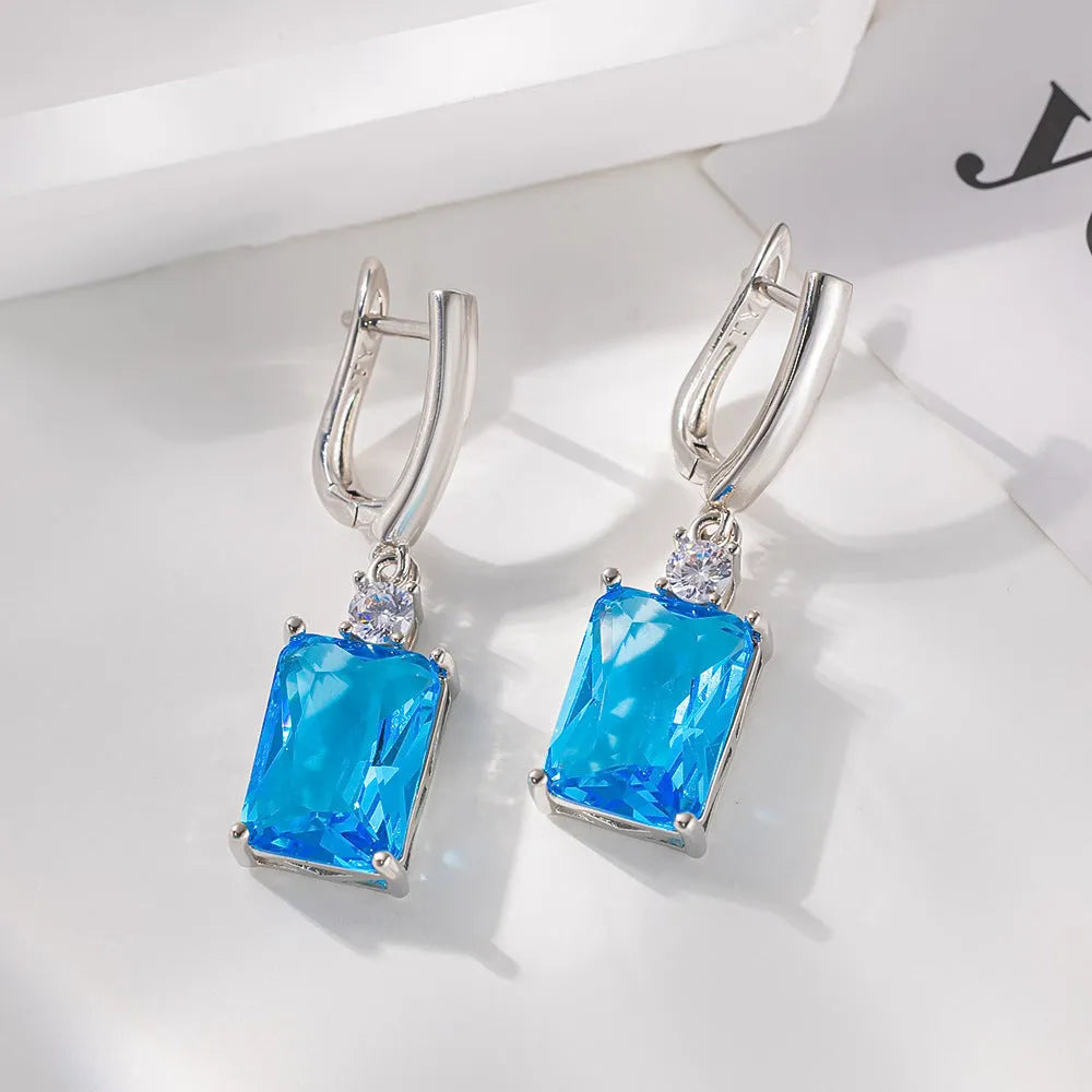 A pair of square geometric copper earrings with a gold electroplated finish.