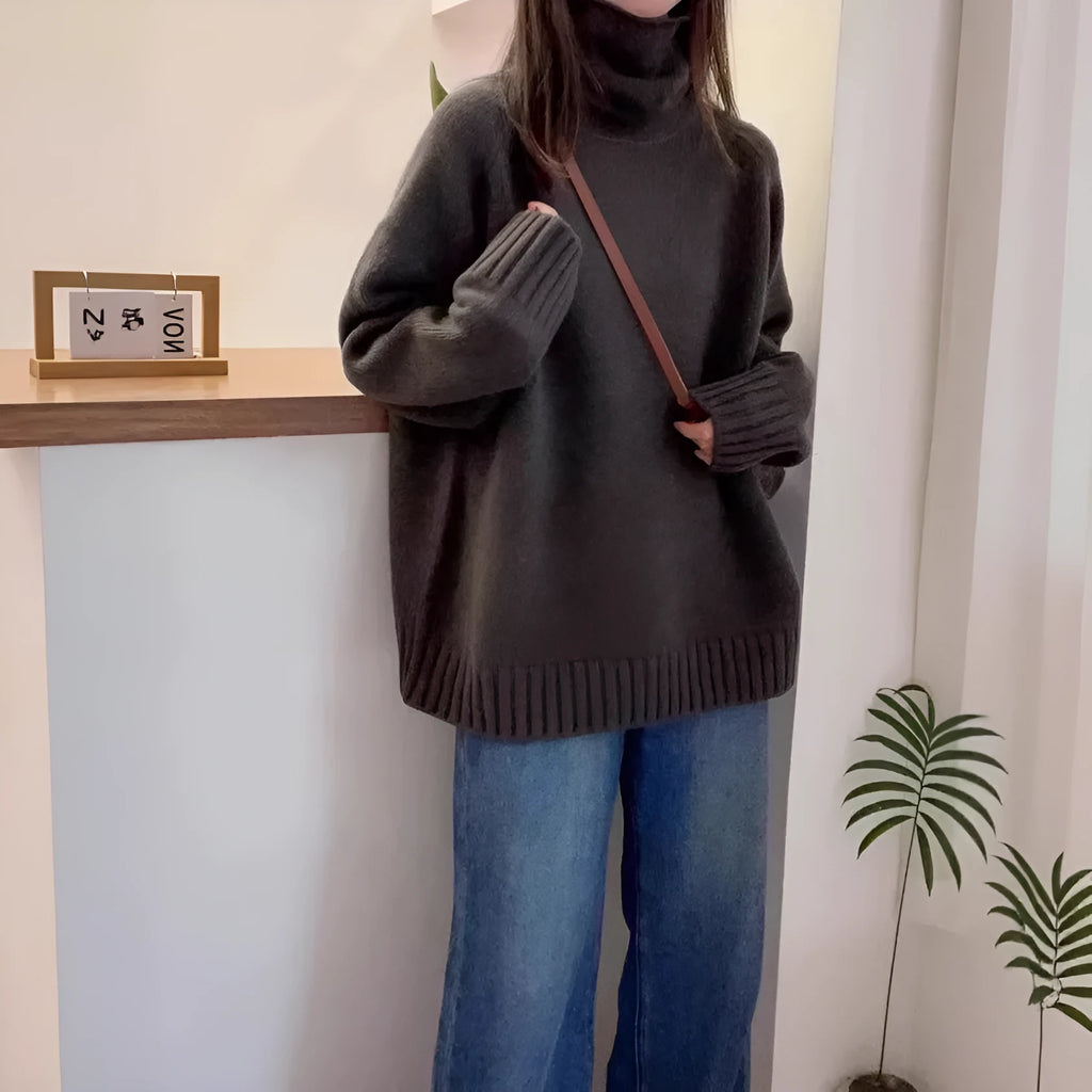 Women's thick grey turtleneck sweater with a textured curling pile collar, loose casual fit.