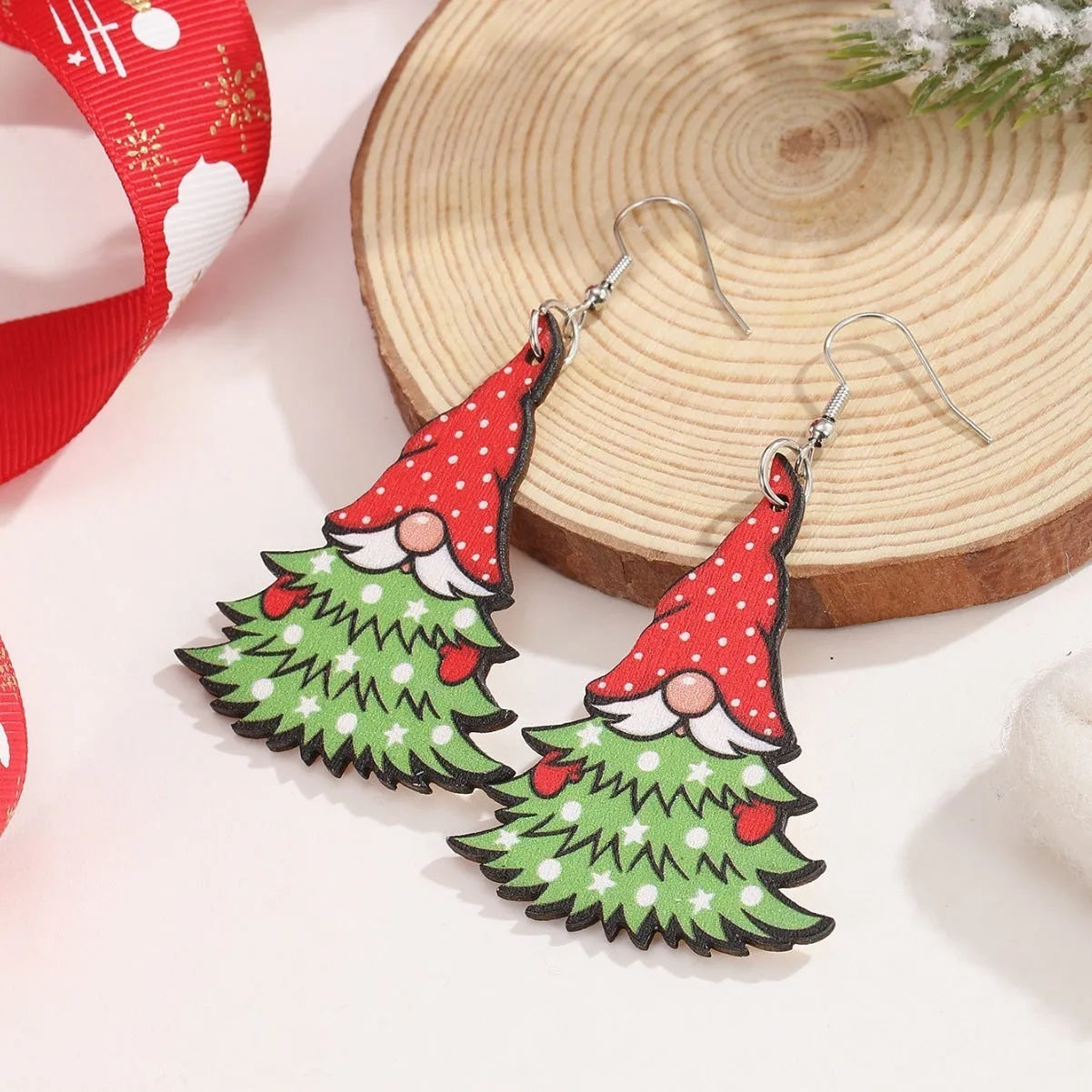 Women's wooden Christmas earrings with printed tree and snowman designs and Santa motifs.