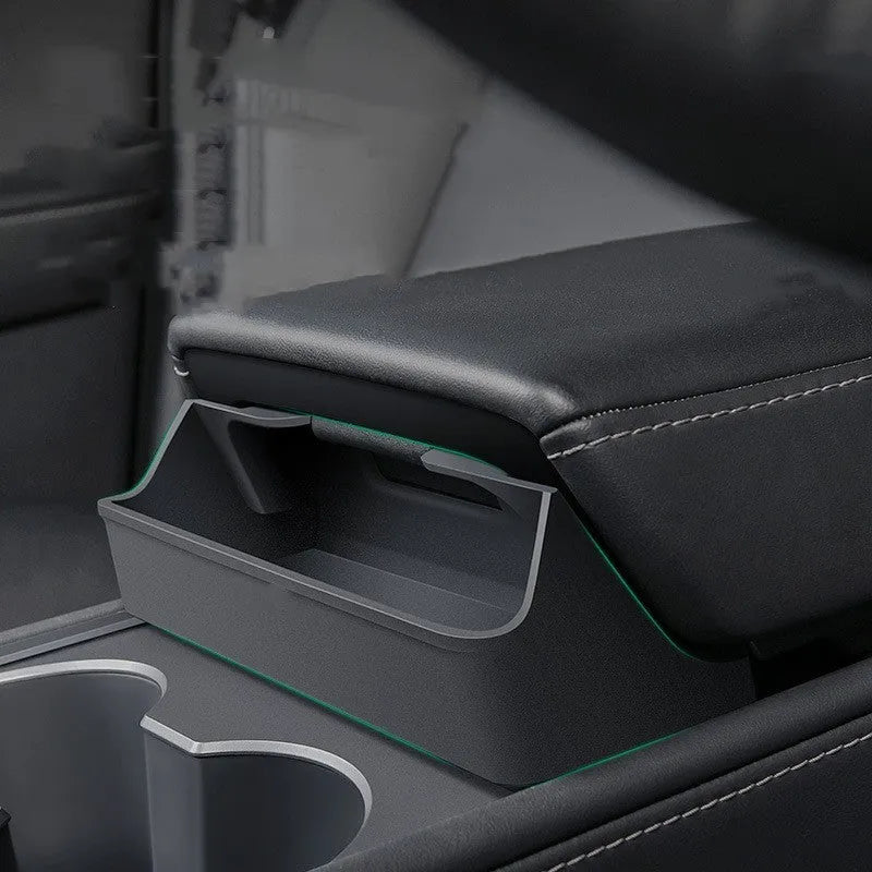 Black silicone glasses case installed inside a Tesla Model 3 or Y centre console armrest.