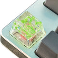 High transparency resin keycap with starry sky design in green, pink, red and violet colours.