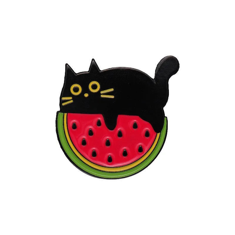 Colourful cartoon-style fruit metal brooch with a pin back on a denim jacket lapel.