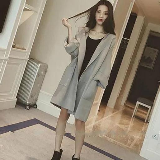 A grey plus size women's loose thin coat with long sleeves and lace detail on a hanger.