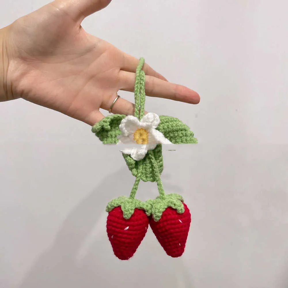 Handmade knitted strawberry shape car pendant made from cotton and hemp.