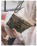 Women's hard-shell PU shoulder and crossbody handbag with hasp closure in black or green.