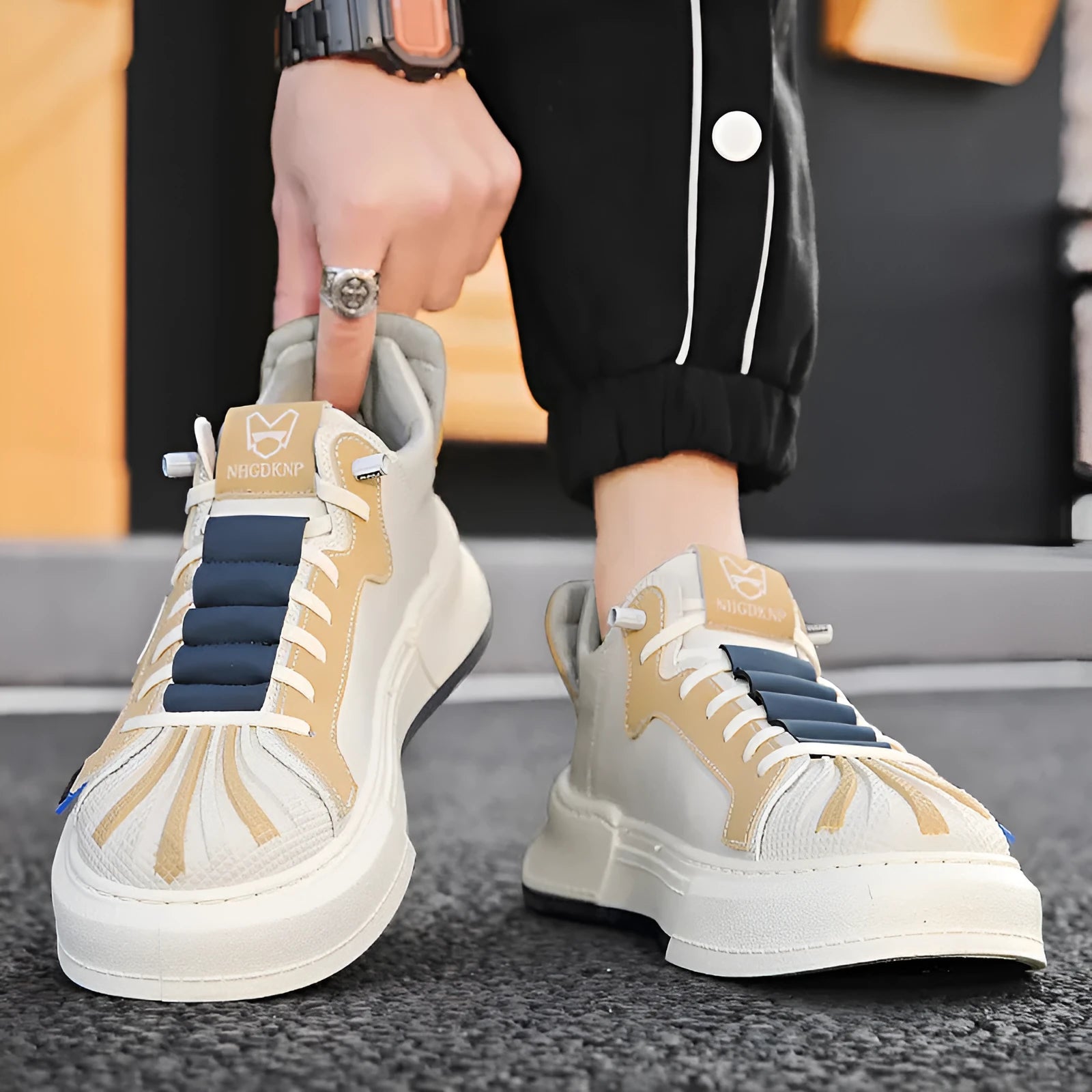 Men's beige low-top casual slip-on shoes with elastic band and leather stitching.