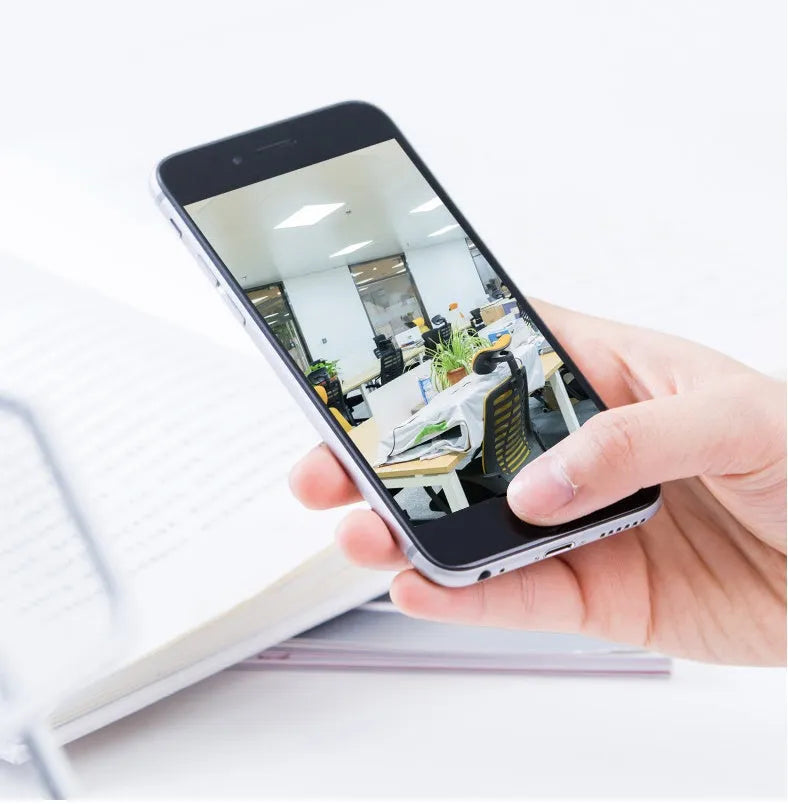 White indoor WiFi security camera with 360-degree rotation on a stand.